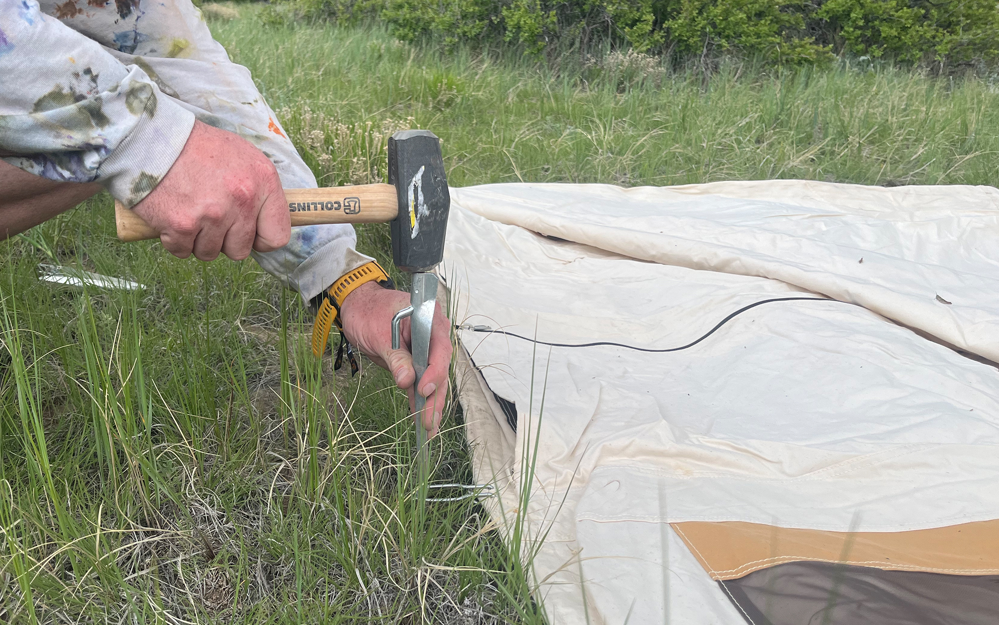 Hammer the stakes so that the hook descends over the steel stake loop.