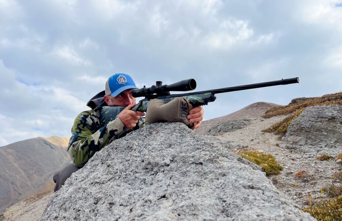 Armageddon Gear Shmedium Game Changer shooting bag and Allterra Arms rifle during a sheep hunt in Alberta with John B. Snow behind taking aim