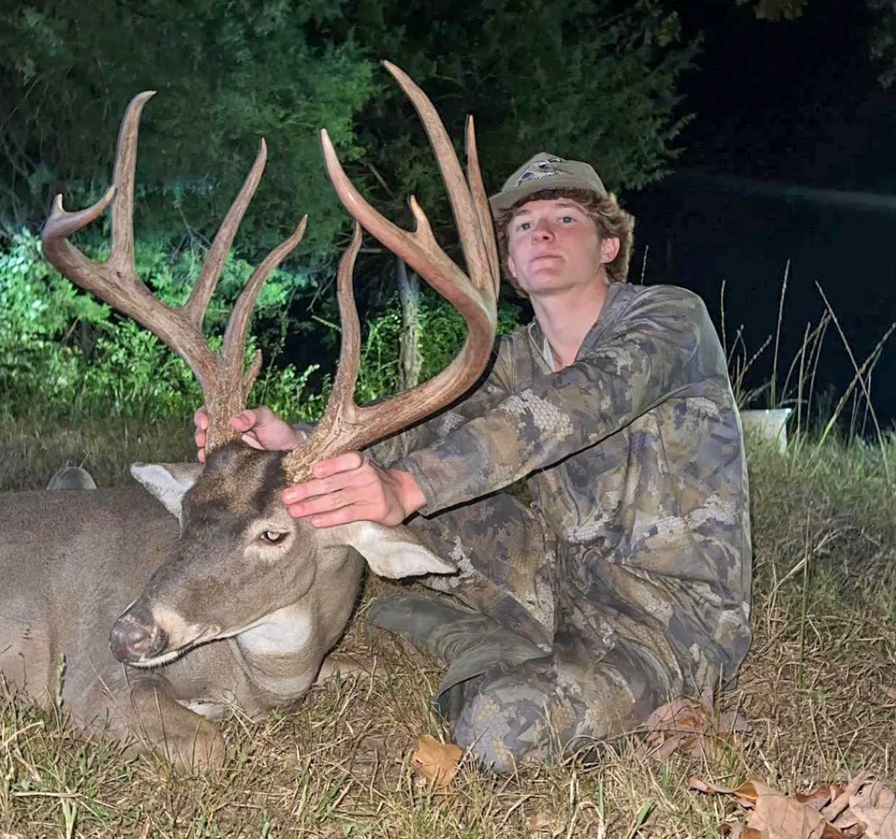 A teen holds up a nice buck.