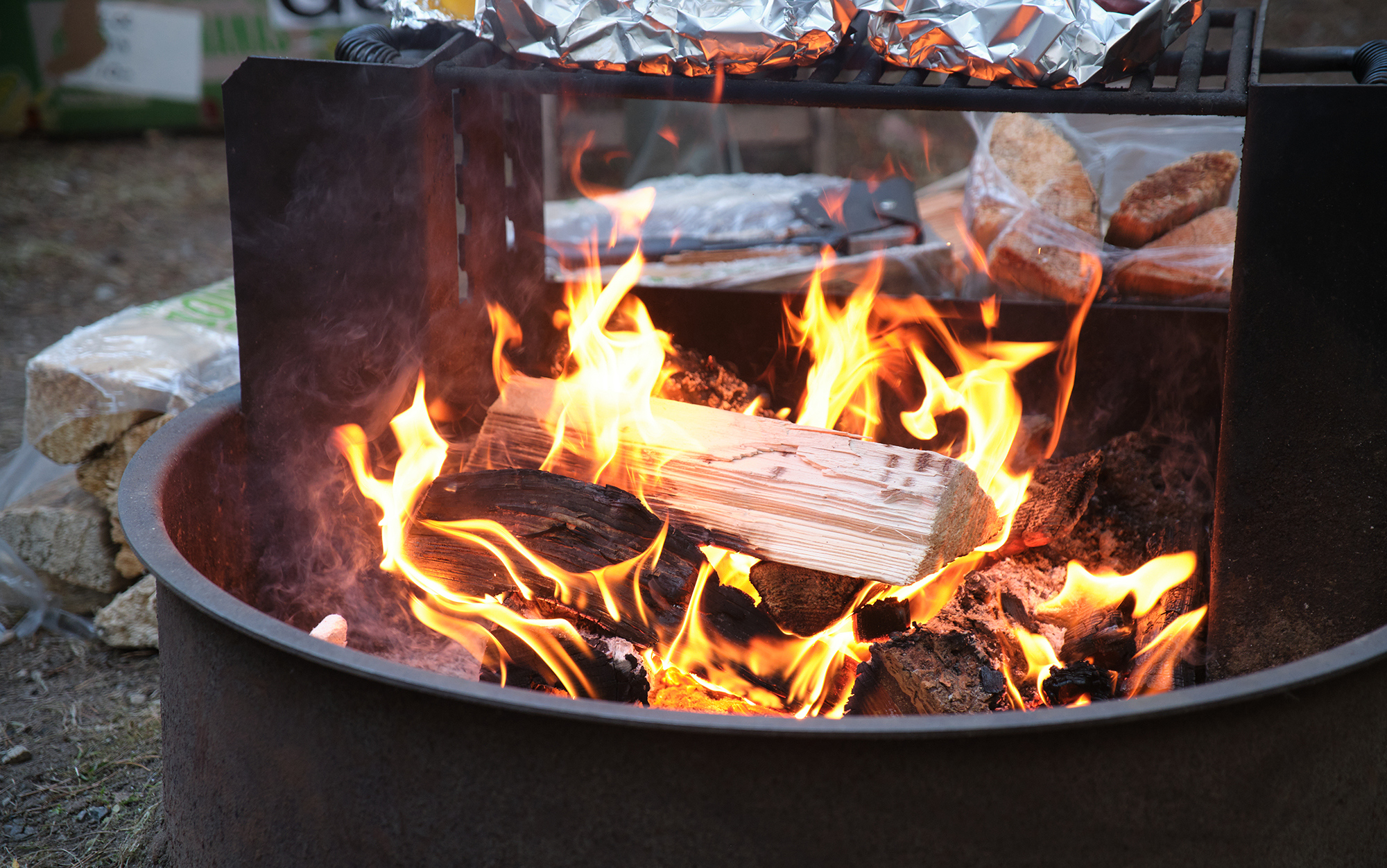 Author cooks food on campfire.