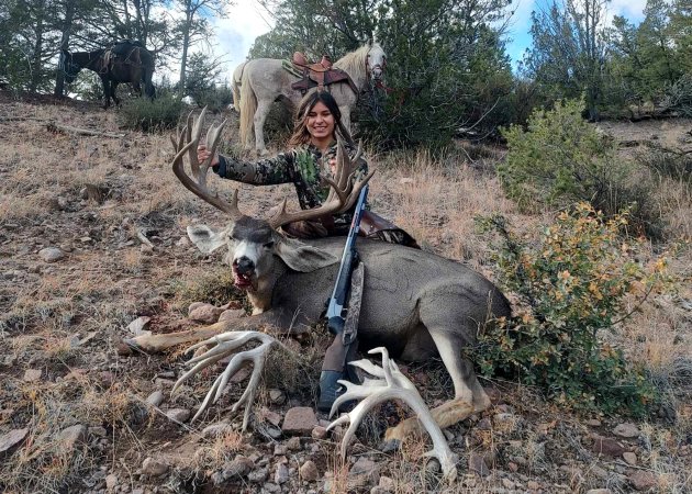 A teen with her giant blackpowder buck.