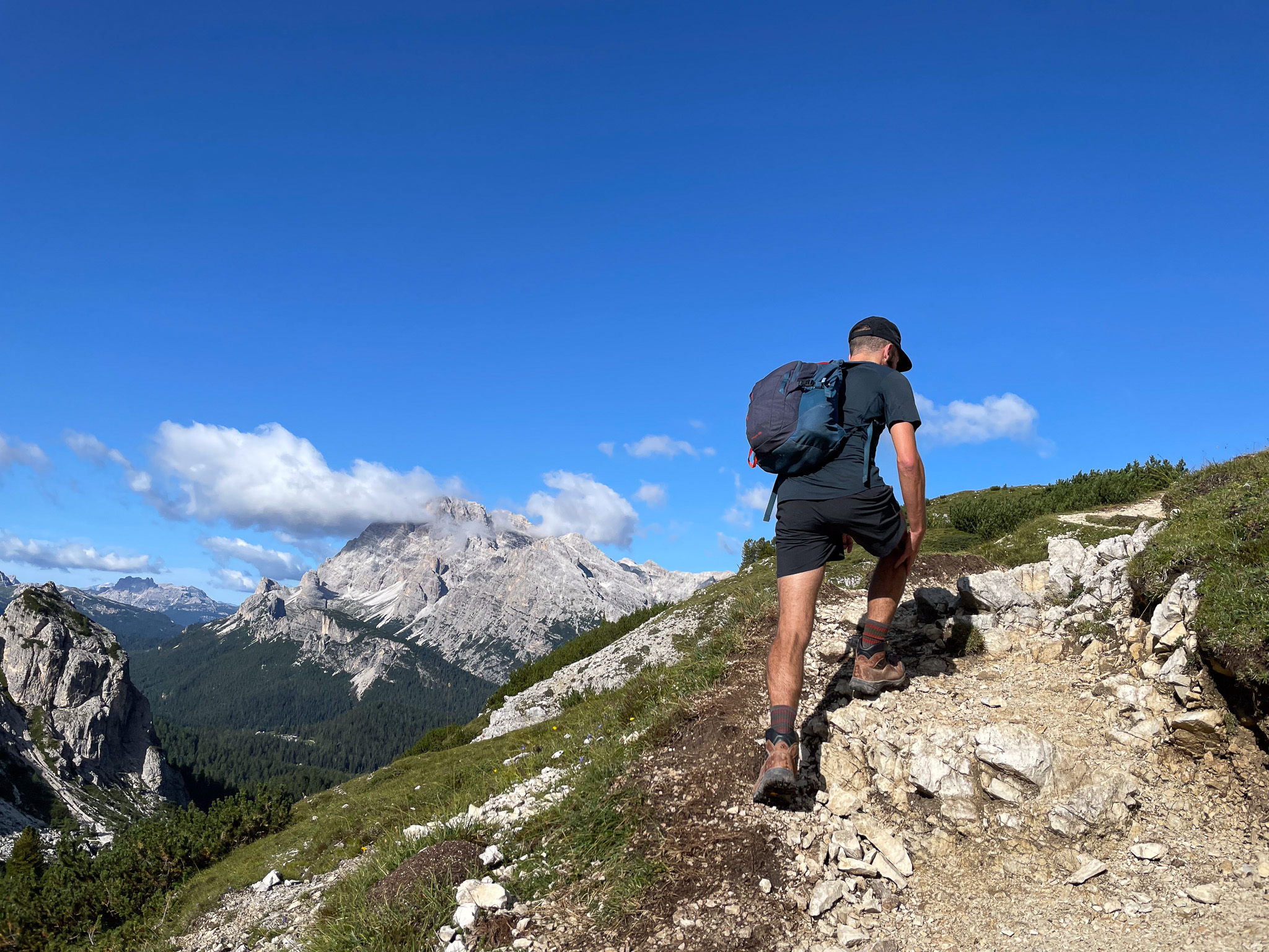 A day hiker climbs a steep trail.