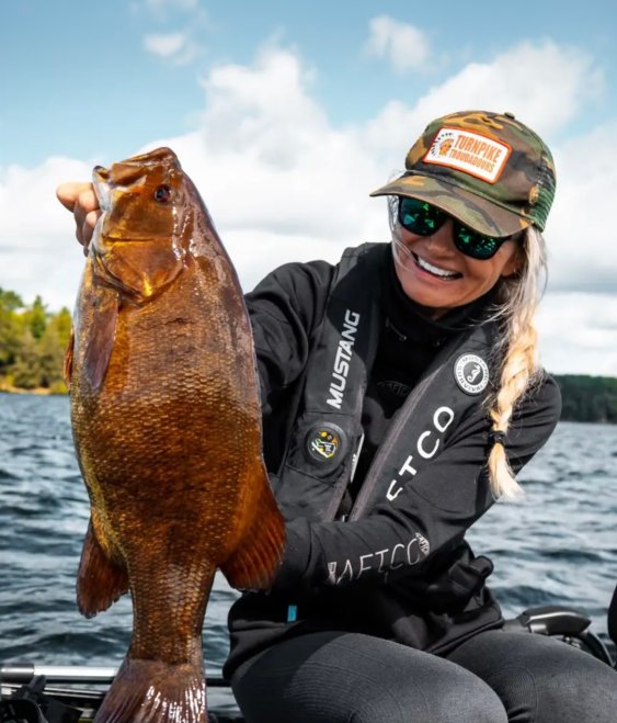 Kristine Fischer holds up a big smallmouth bass