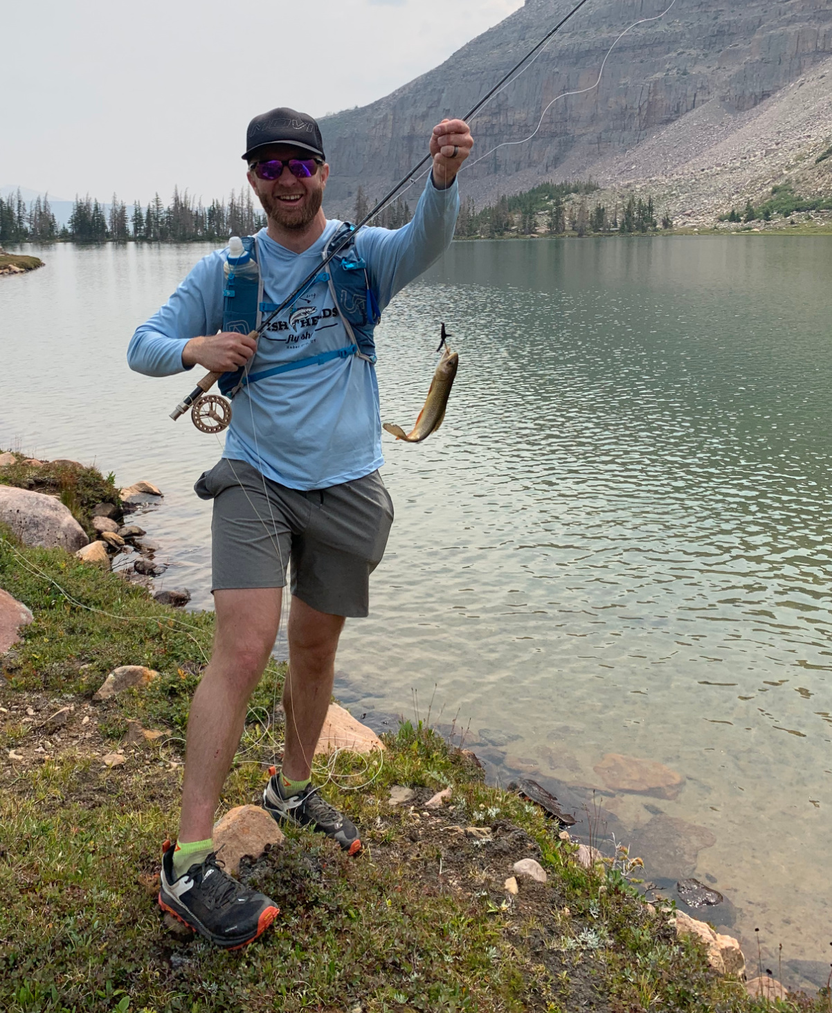 Brian Beckstead holds up a fish.