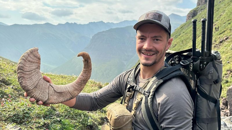 Michel Beaulieu poses with a shed bighorn sheep horn.