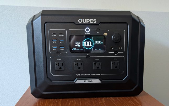 Oupes Mega 1 with all the ports activated sitting on a wooden table against a white wall