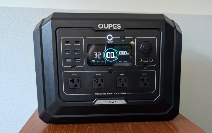  Oupes Mega 1 with all the ports activated sitting on a wooden table against a white wall