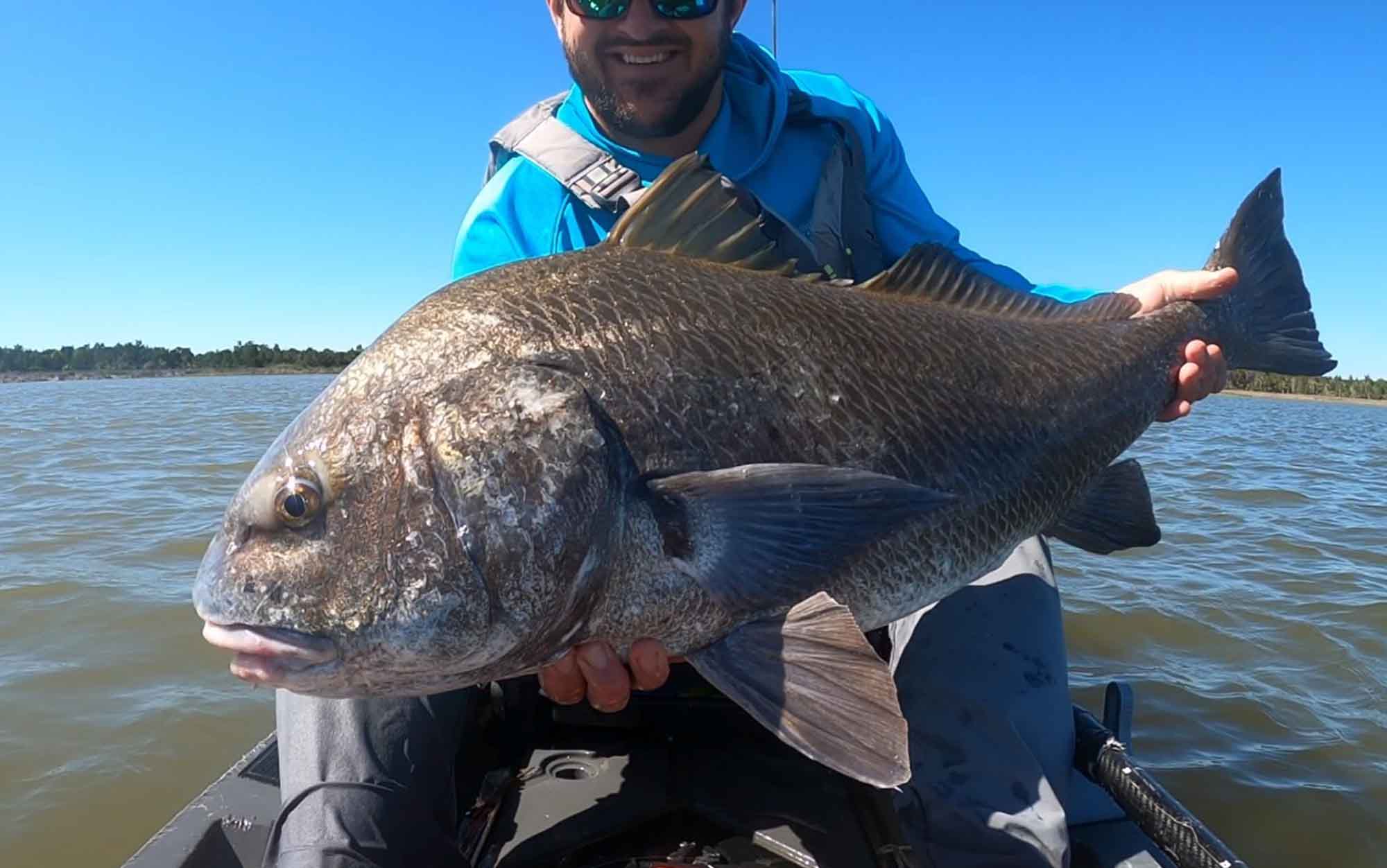 Author holds giant black drum.