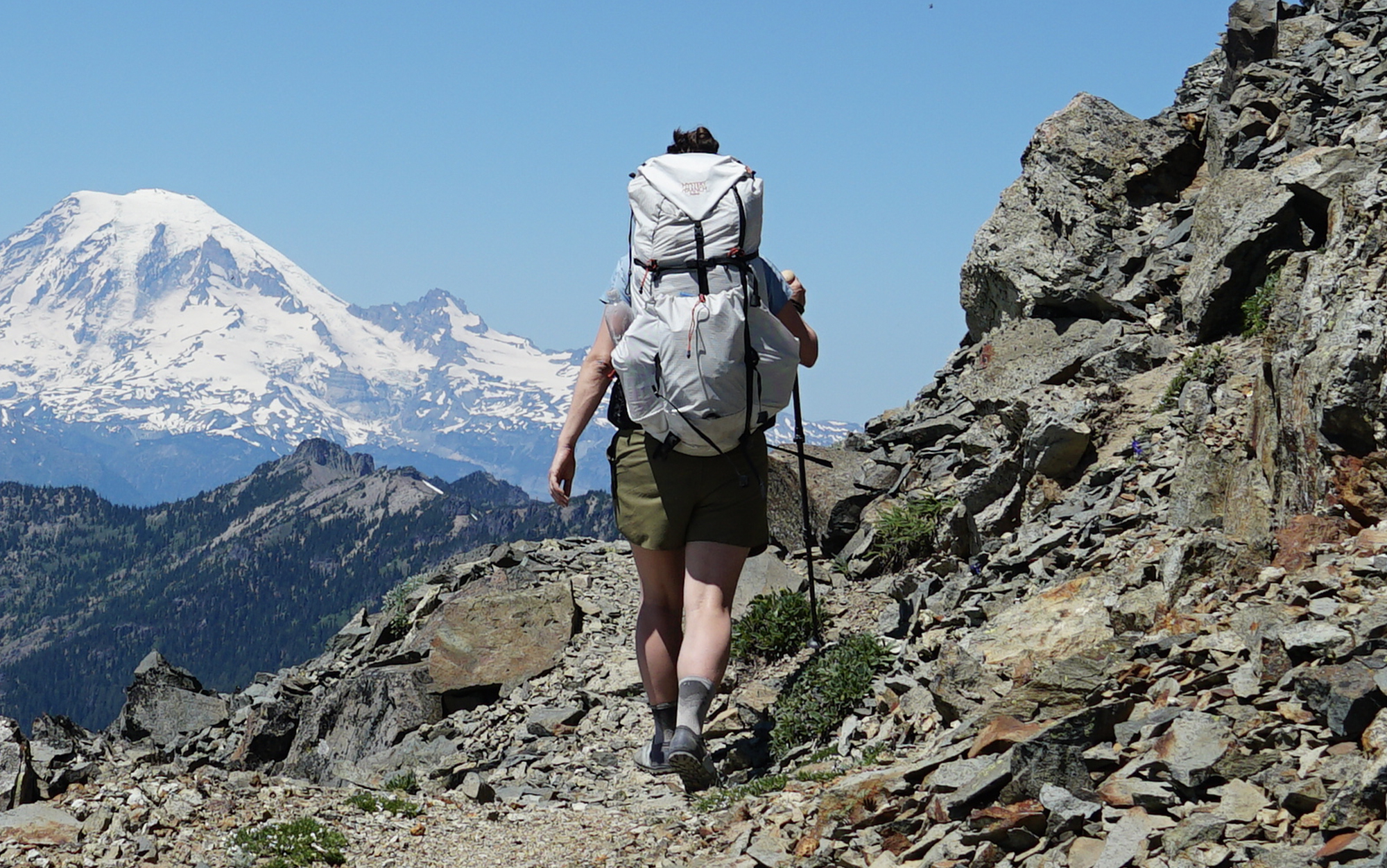 Hiking along the edge of a scree field in the Softstar Primals.