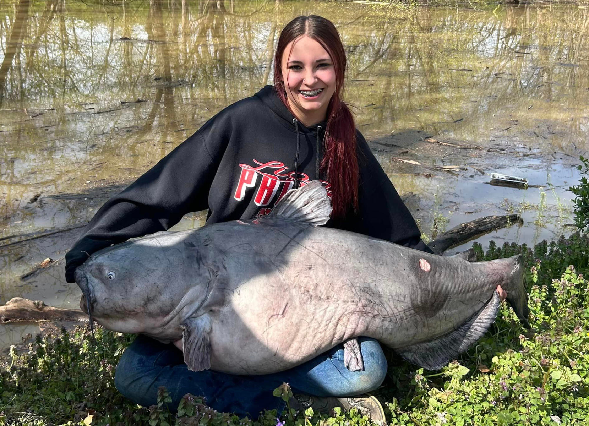 Jaylynn Parker holds a blue catfish.