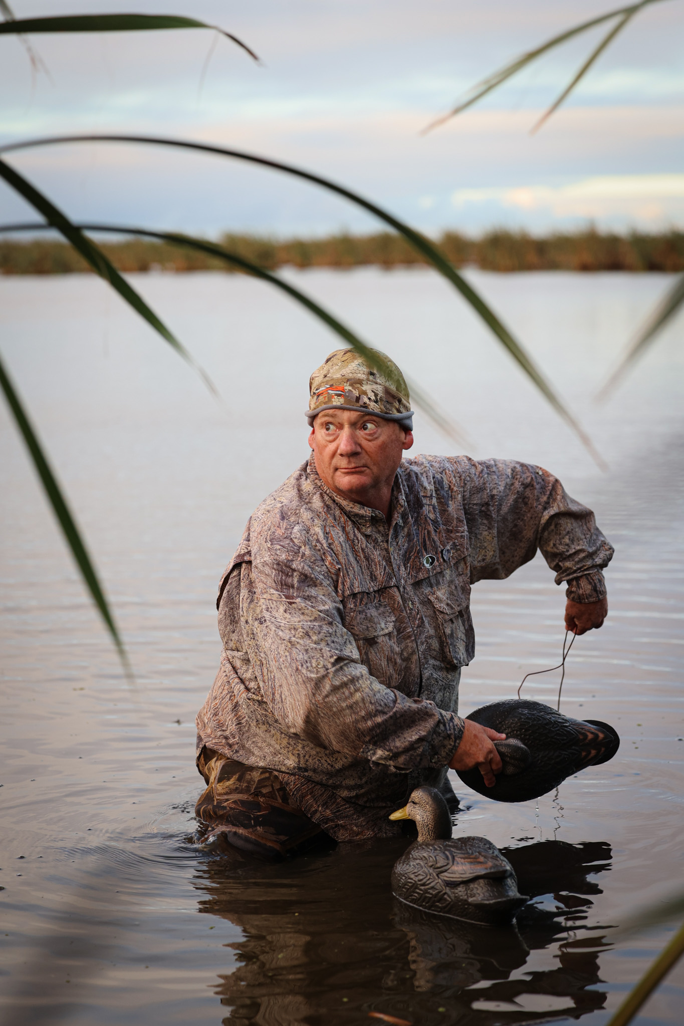 A duck hunter tosses out decoys in Australia.