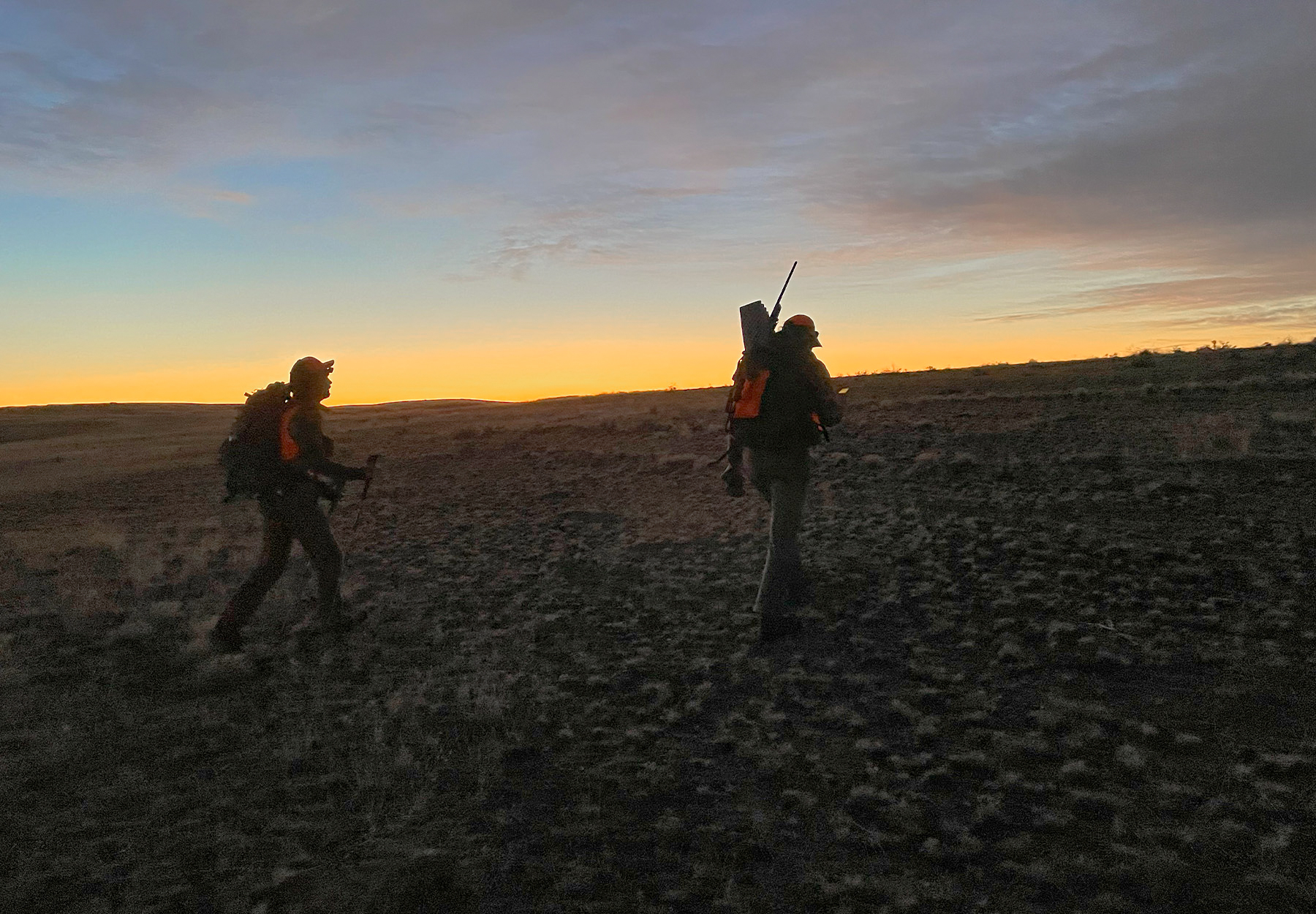 Hunters hiking at sunrise.