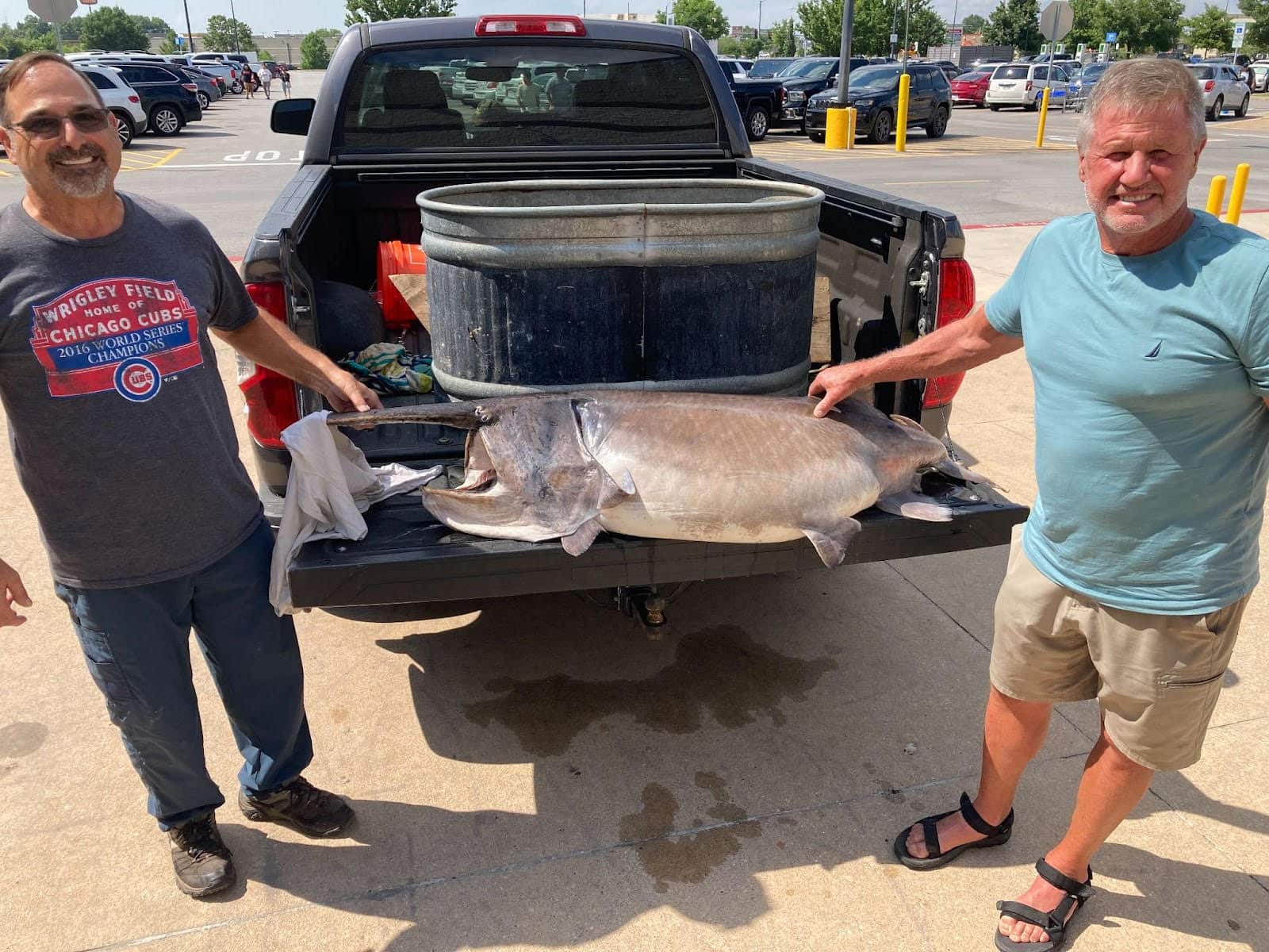 Two Arkansas men with a paddlefish.