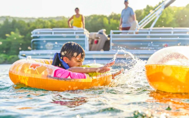 Child splashes in floating tube.