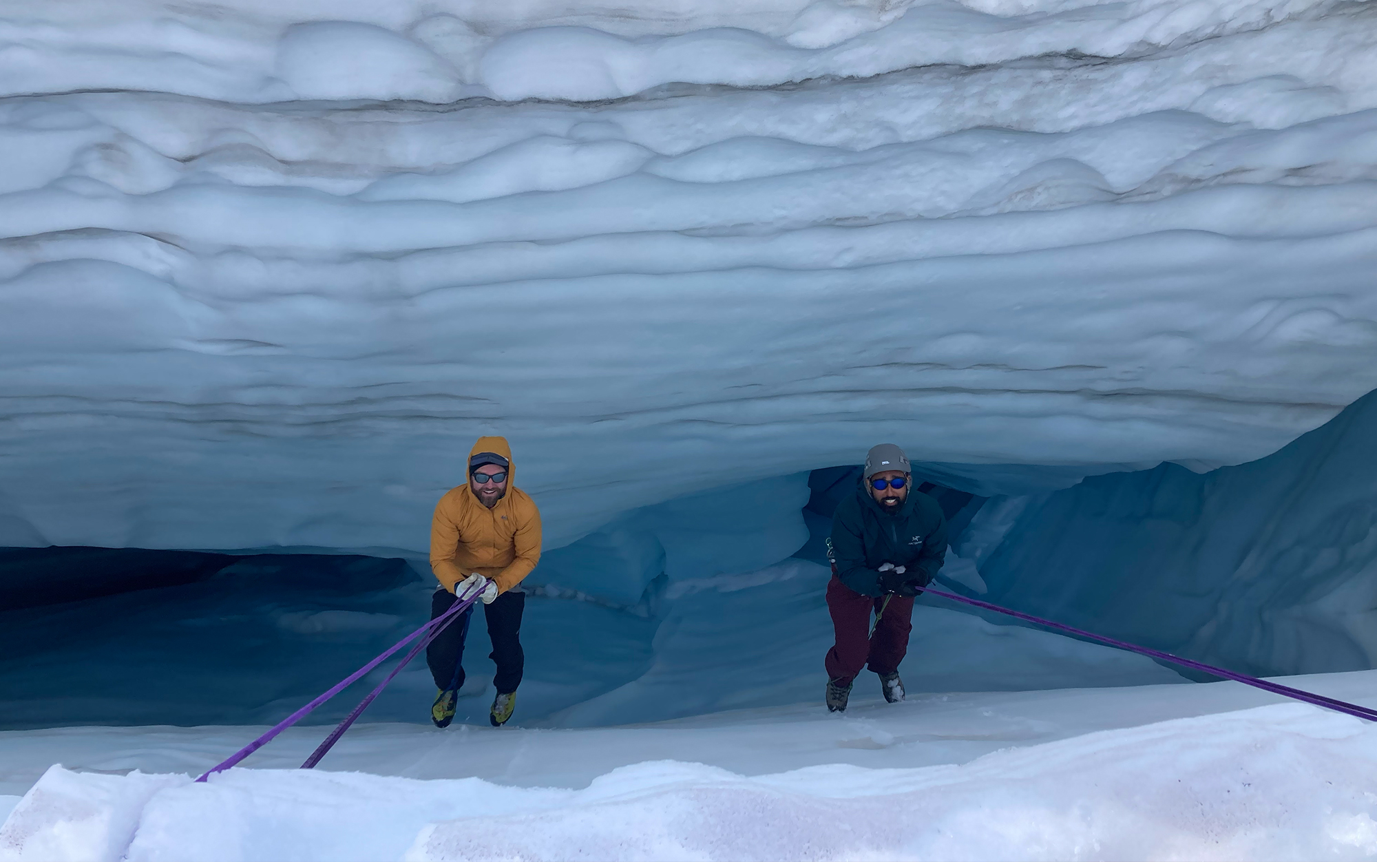 Two mountaineers practice a crevasse rescue.