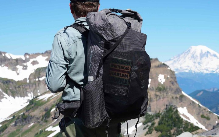  man staring out at mountain range wearing the Black Diamond Beta Light backpack