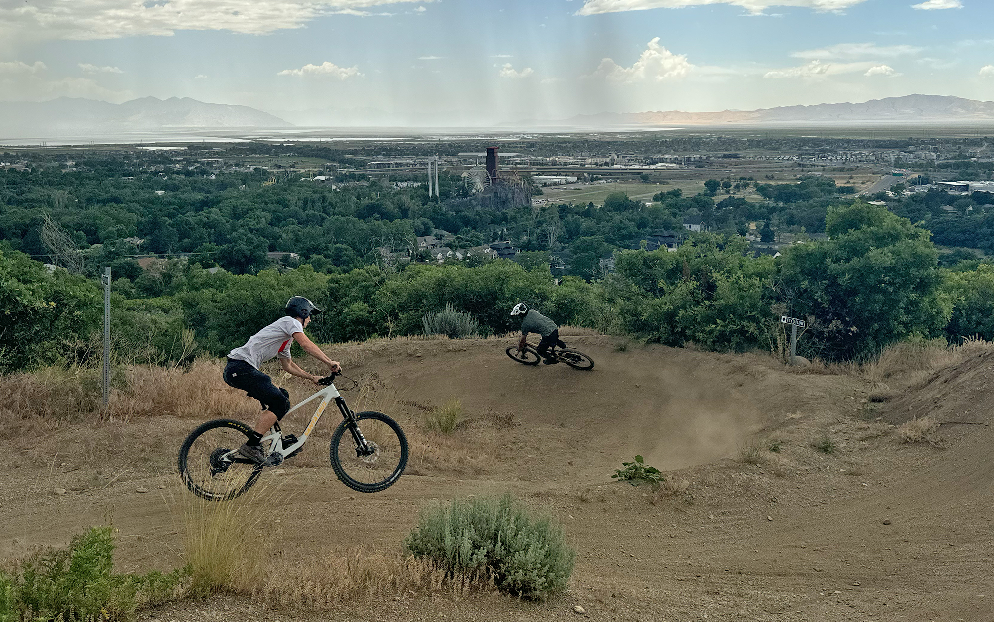Two bikers ride a berm on the Bronson and Rallon.