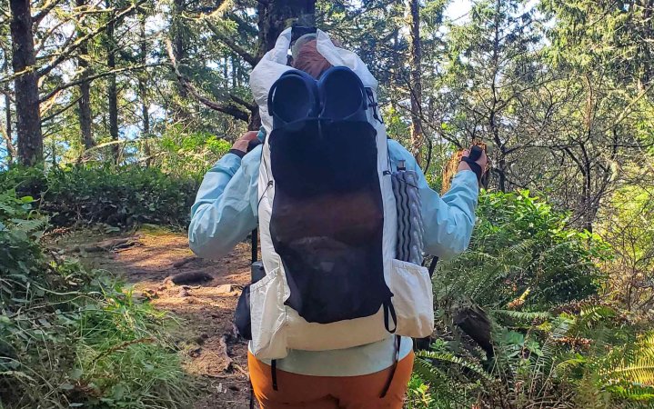  woman hiking through forest with the crop on the OV CS40 backpack