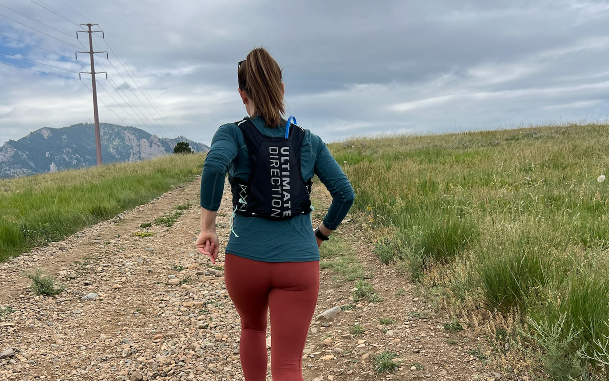 Hill runs on a dirt road in one of the best running vests.