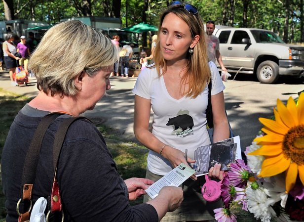 HSUS's Maine state director, Katie Hansberry, hands out pamphlets at farmers market in the state in 2013, urging a referendum to be put on the ballot to ban bear hunting by baiting, with hounds or by trapping.