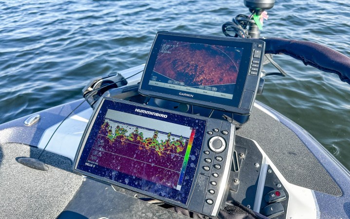 A Humminbird and Garmin fish finder on the deck of a boat.