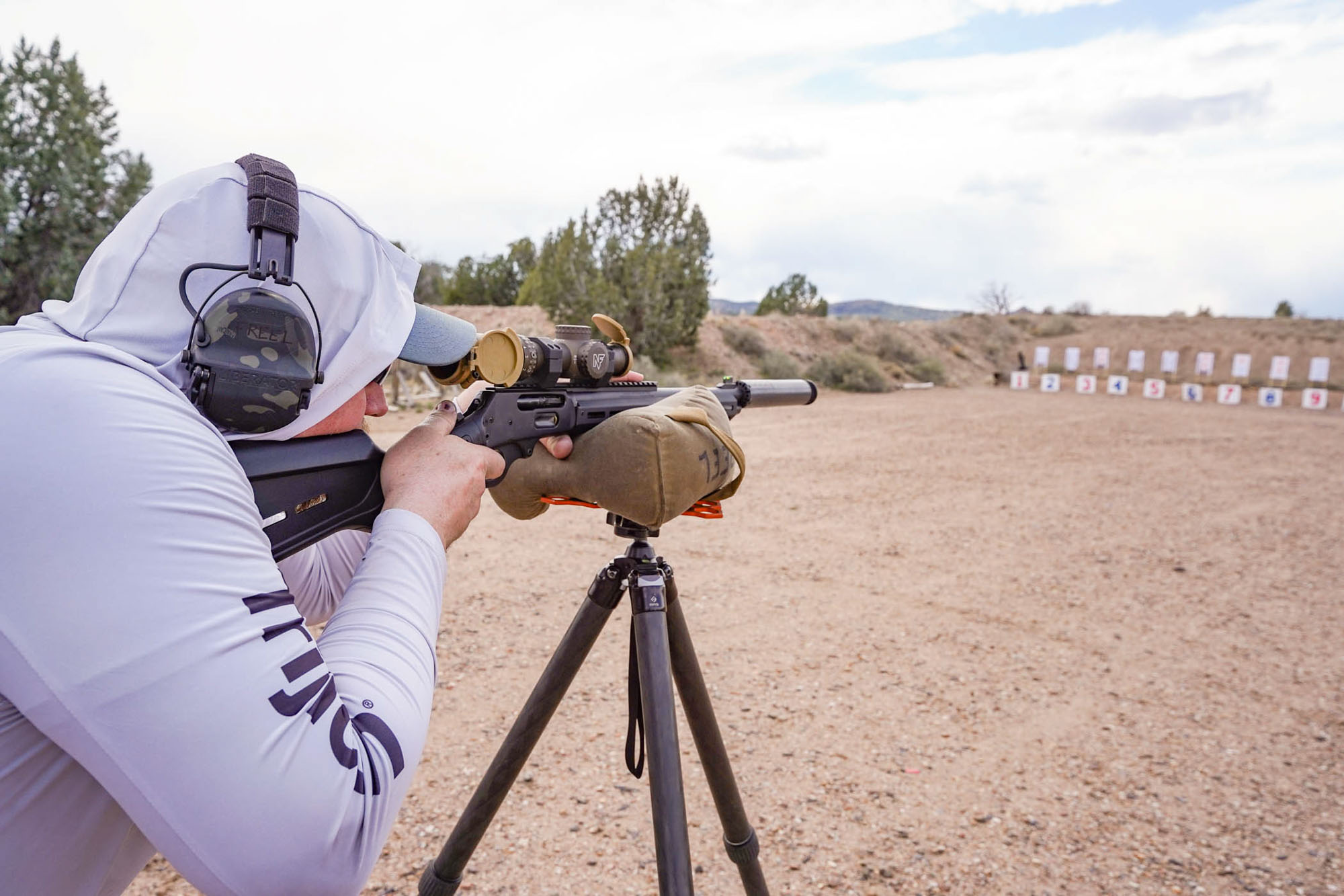 Shooting a lever action off a tripod and bag for accuracy.