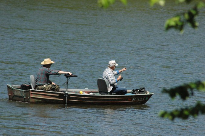 Two men catfishing in a boat