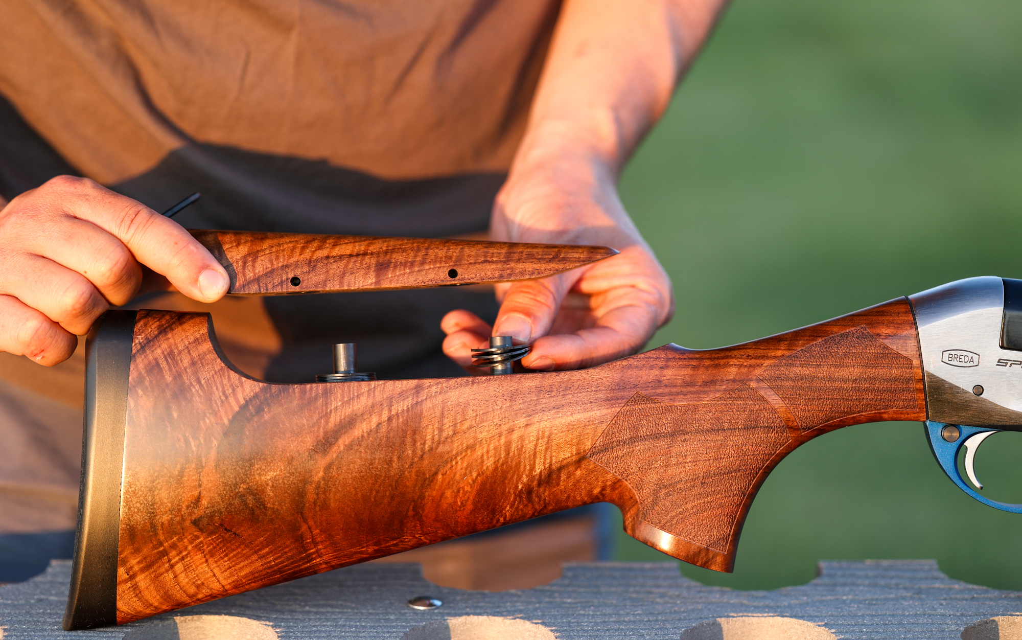 Adjusting the cheekpiece on a shotgun.