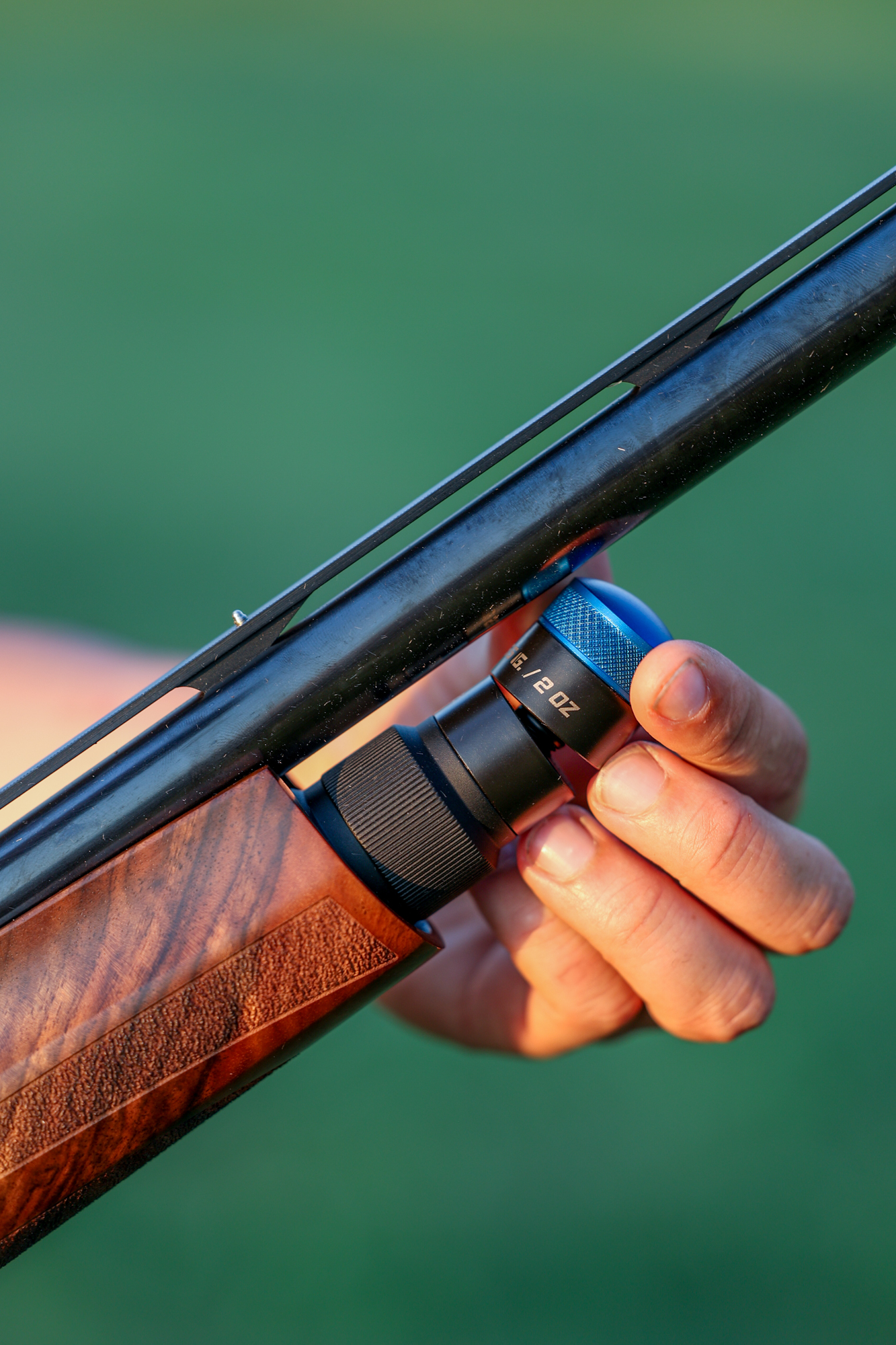 Adding weight to a sporting shotgun.