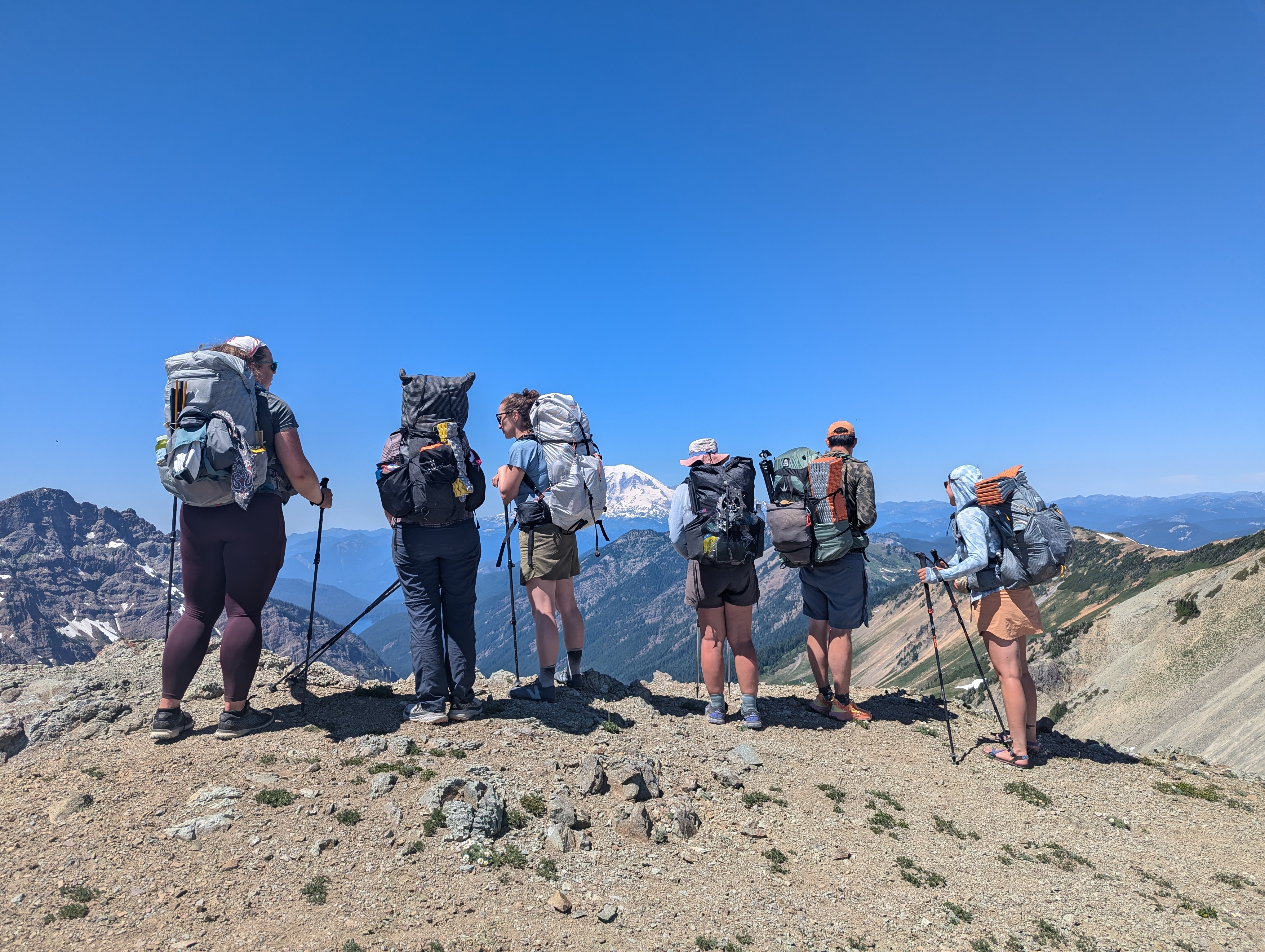 Backpackers stand at overlook.