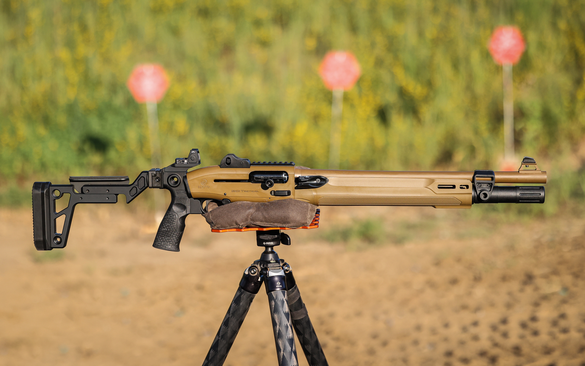  The Beretta 1301 Mod 2 resting on a tripod with steel targets in the background.