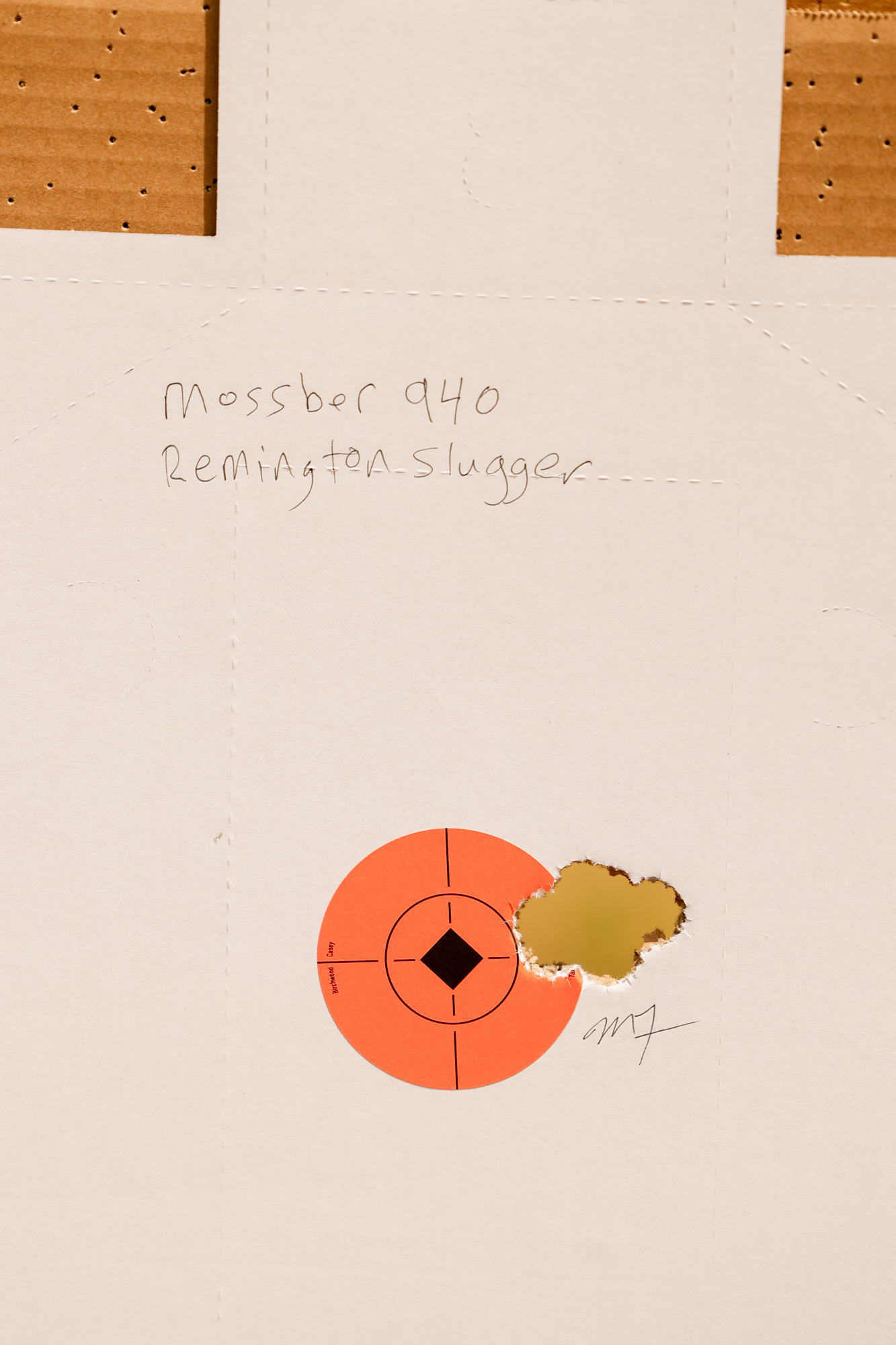 The Mossberg 940 shot a tight group of holes in a target with slugs.