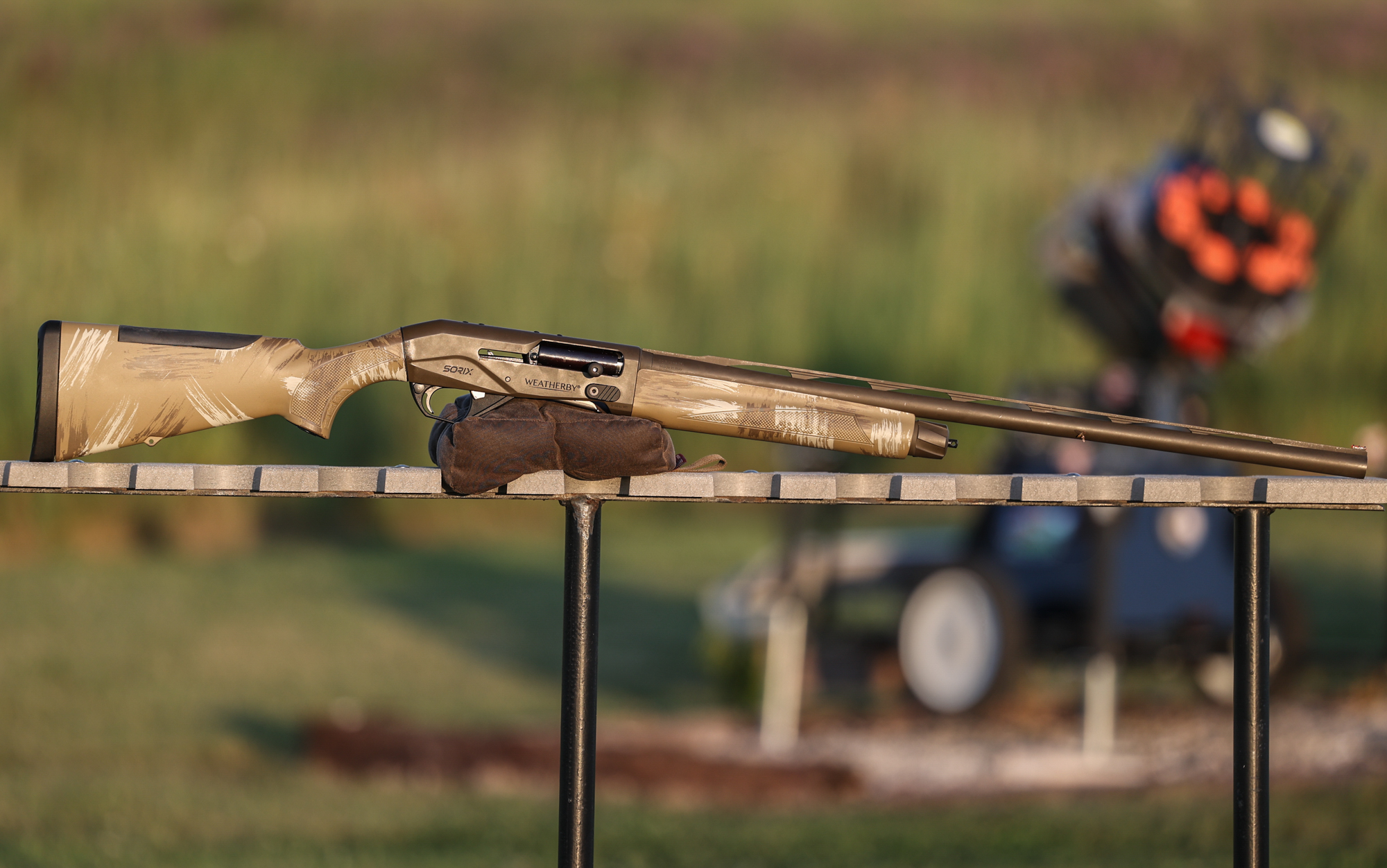  The Weatherby Sorix duck gun rests on a shooting bag on a table at the range.