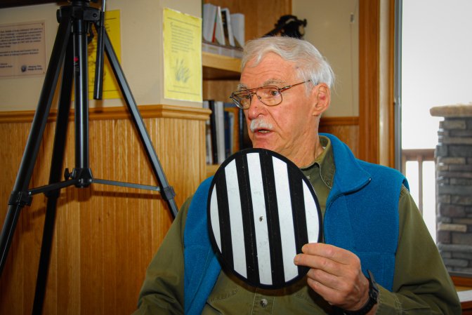 Bill McRae holds up a resolution wheel.