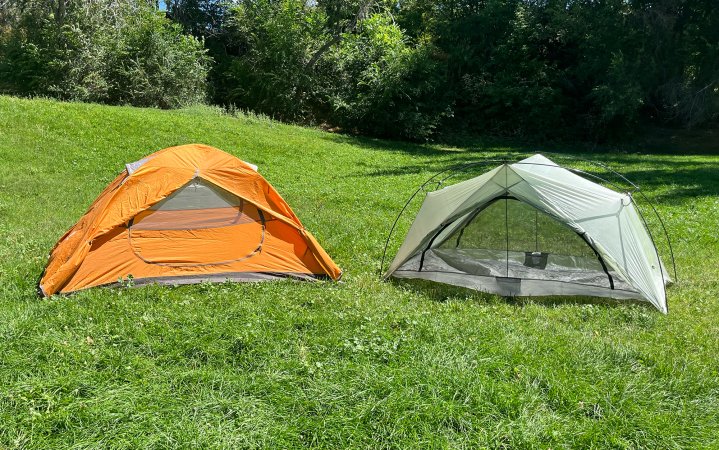 Cheap and expensive backpacking tents set up side by side.