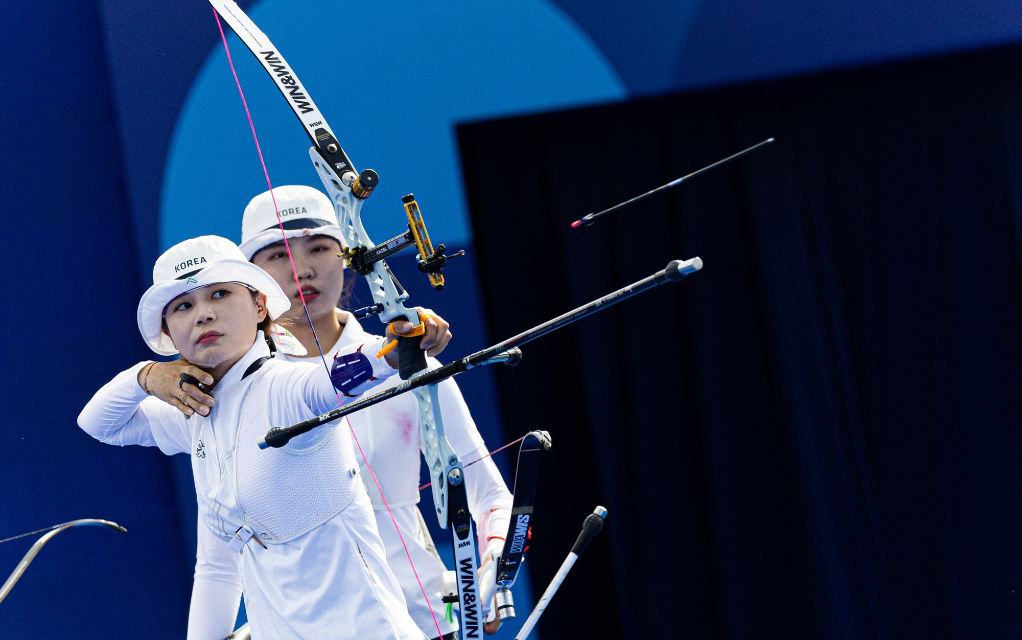 Korean archers let arrows fly during the Olympic games.