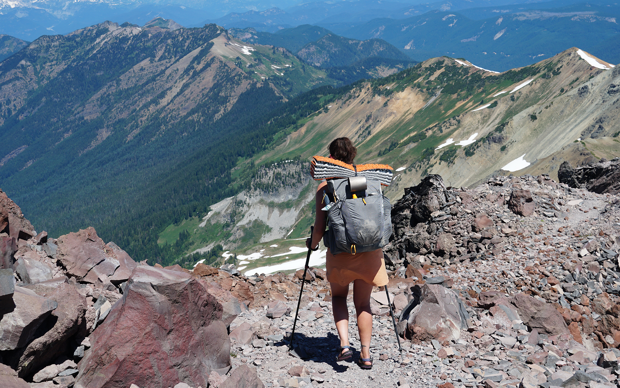 Author walks down shale covered trail using the best trekking poles.