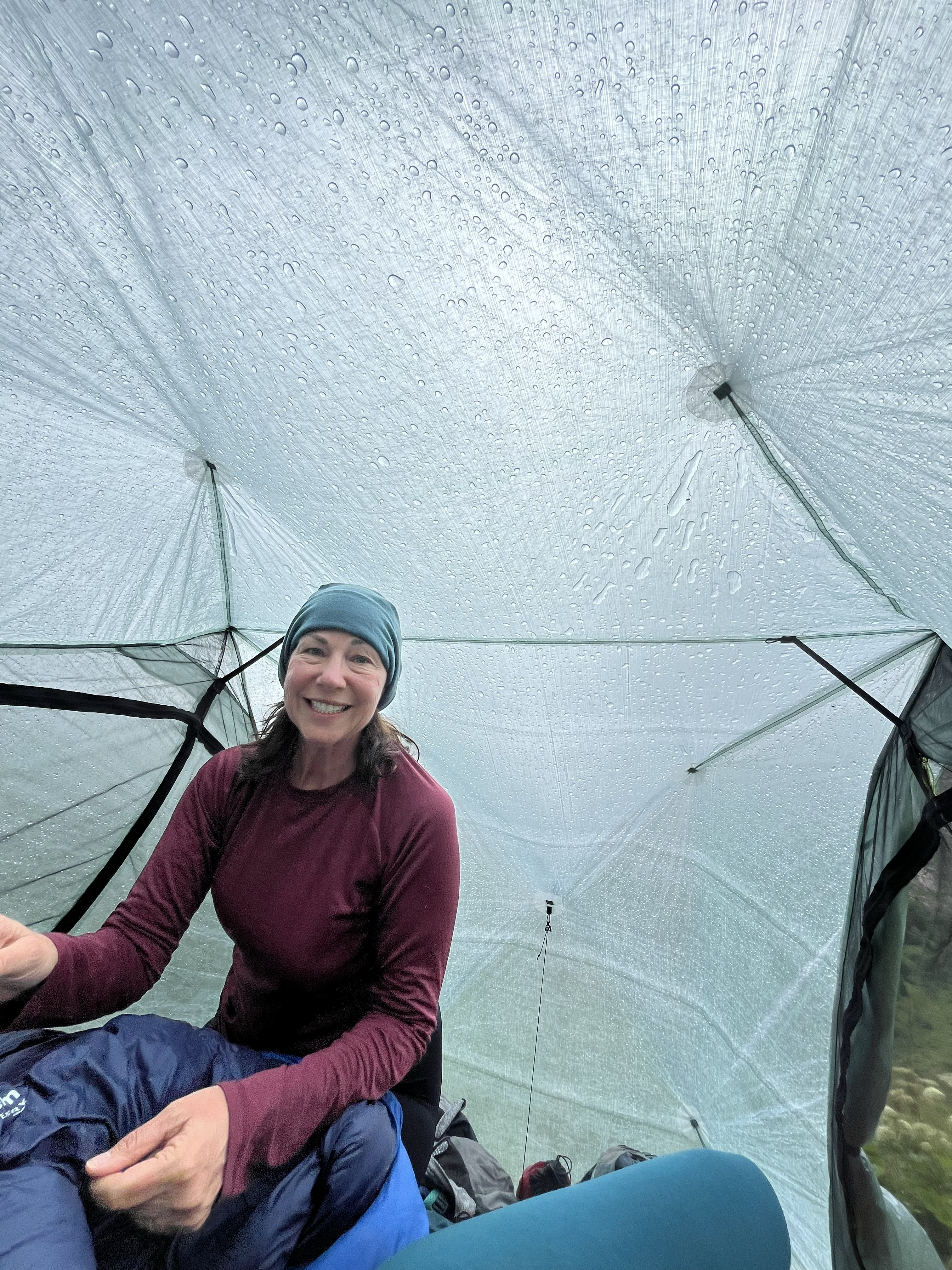 Backpacker sits up in Zpacks tent.