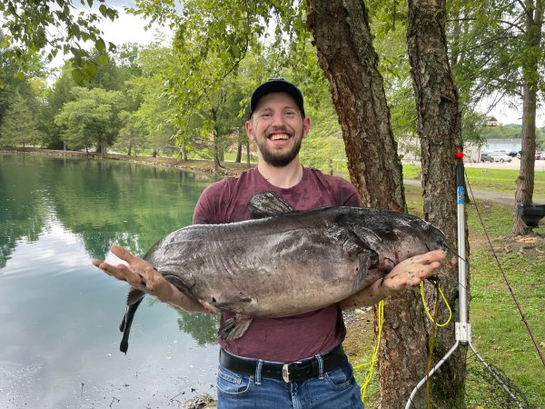 Man holds large channel catfish.