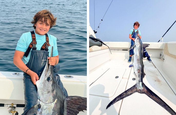 A 12-year-old holds up a white marlin.