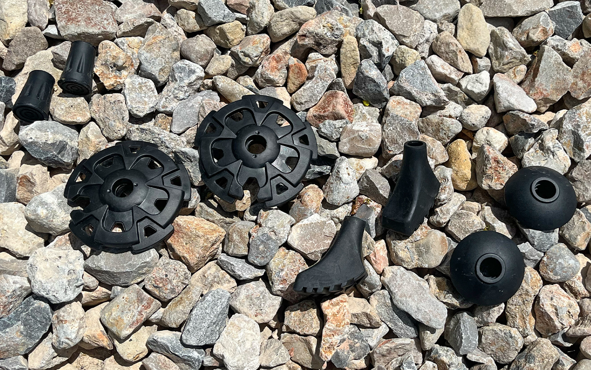 Trekking pole tips and baskets laid out.