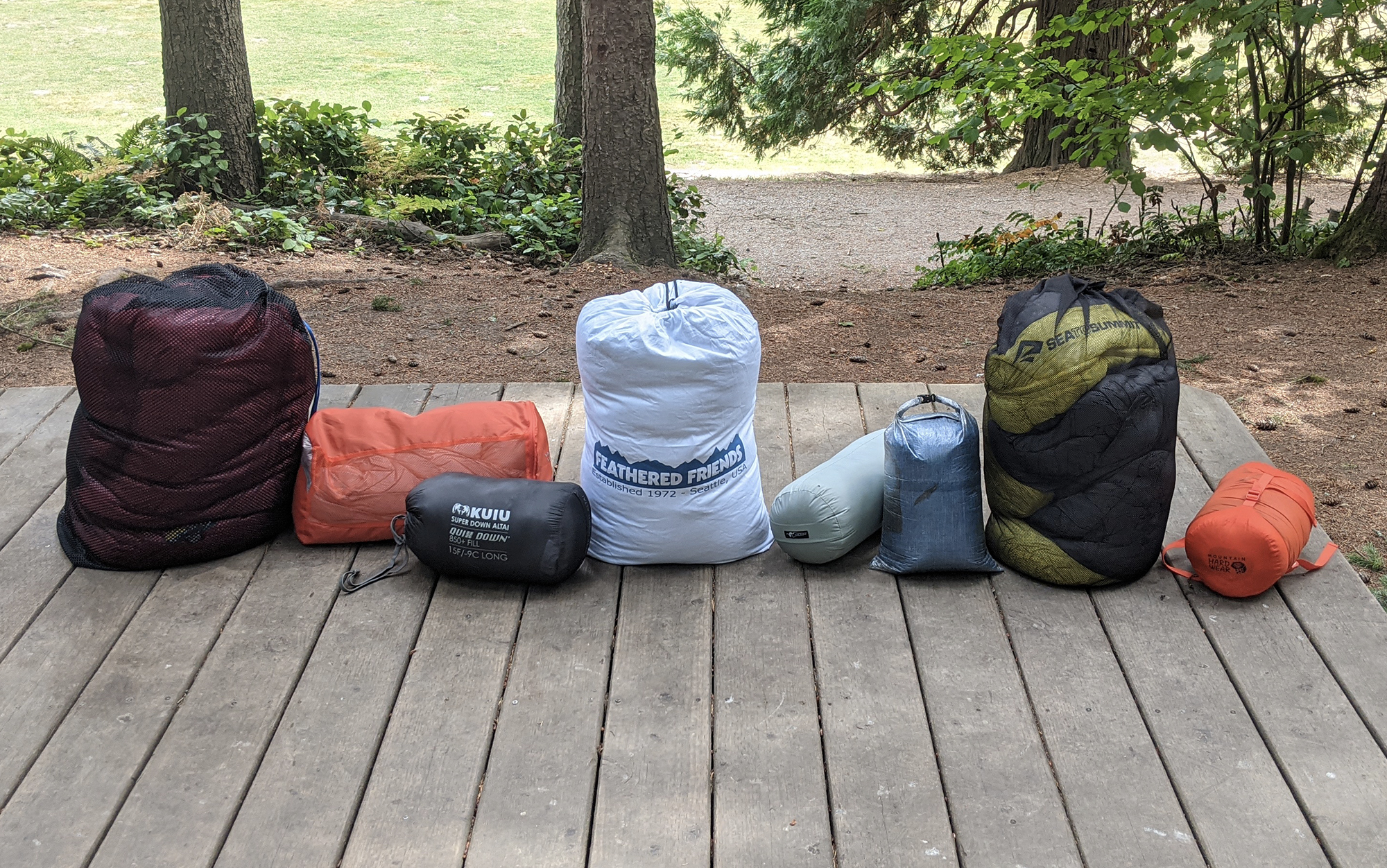 A row of ultralight sleeping bags packed into bags