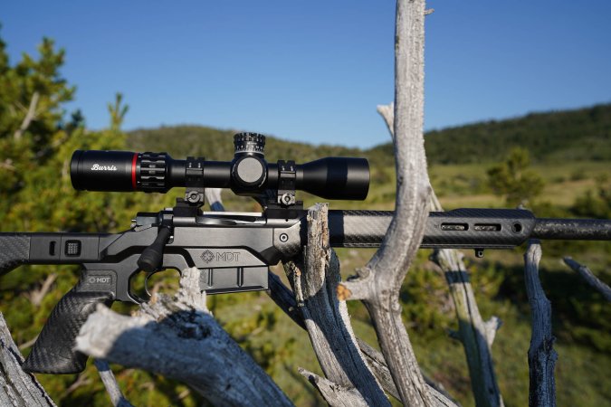  The Burris Veracity is mounted to a rifle sitting in a tree.