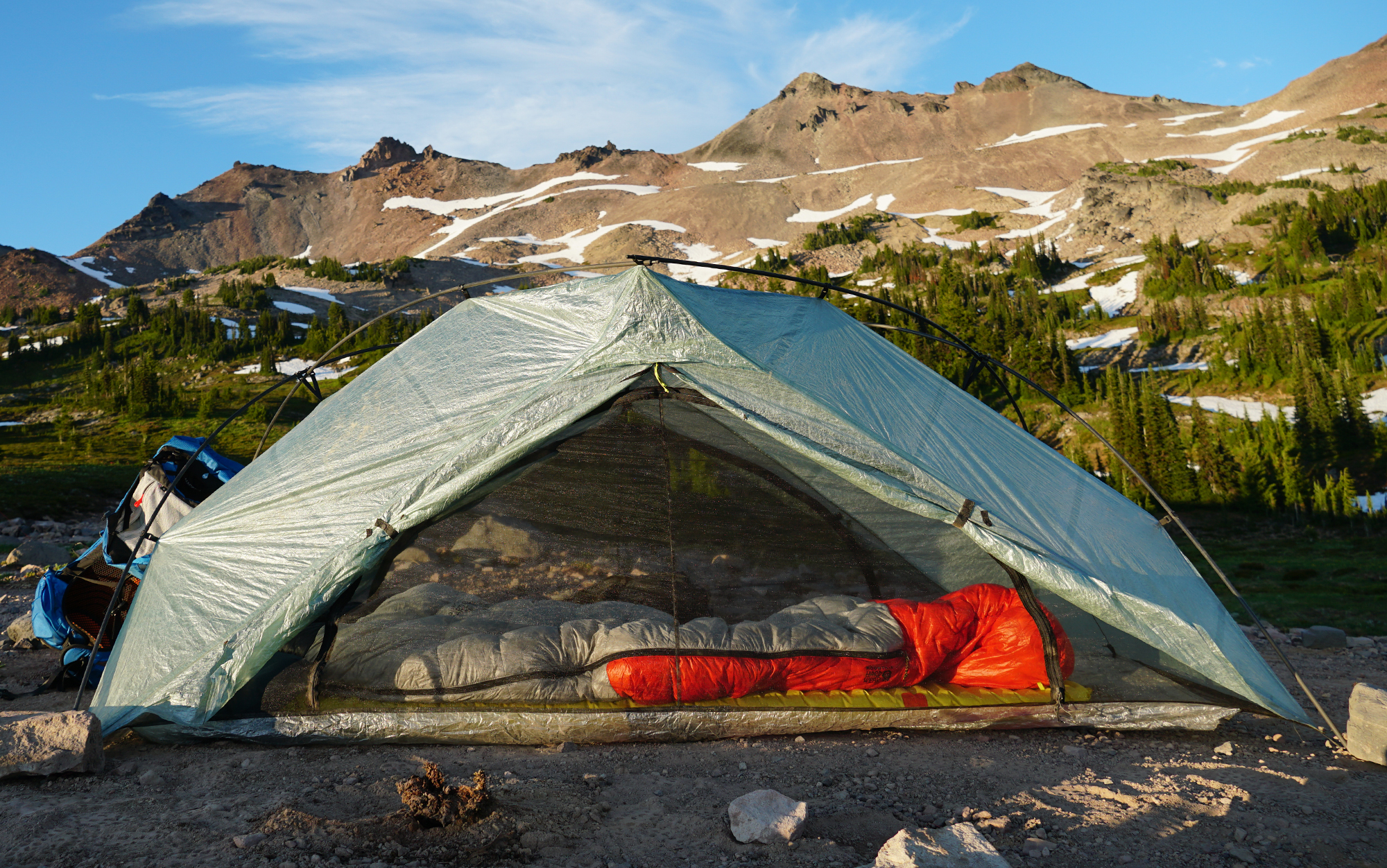 The Zpacks tent is set up in front of a mountain.