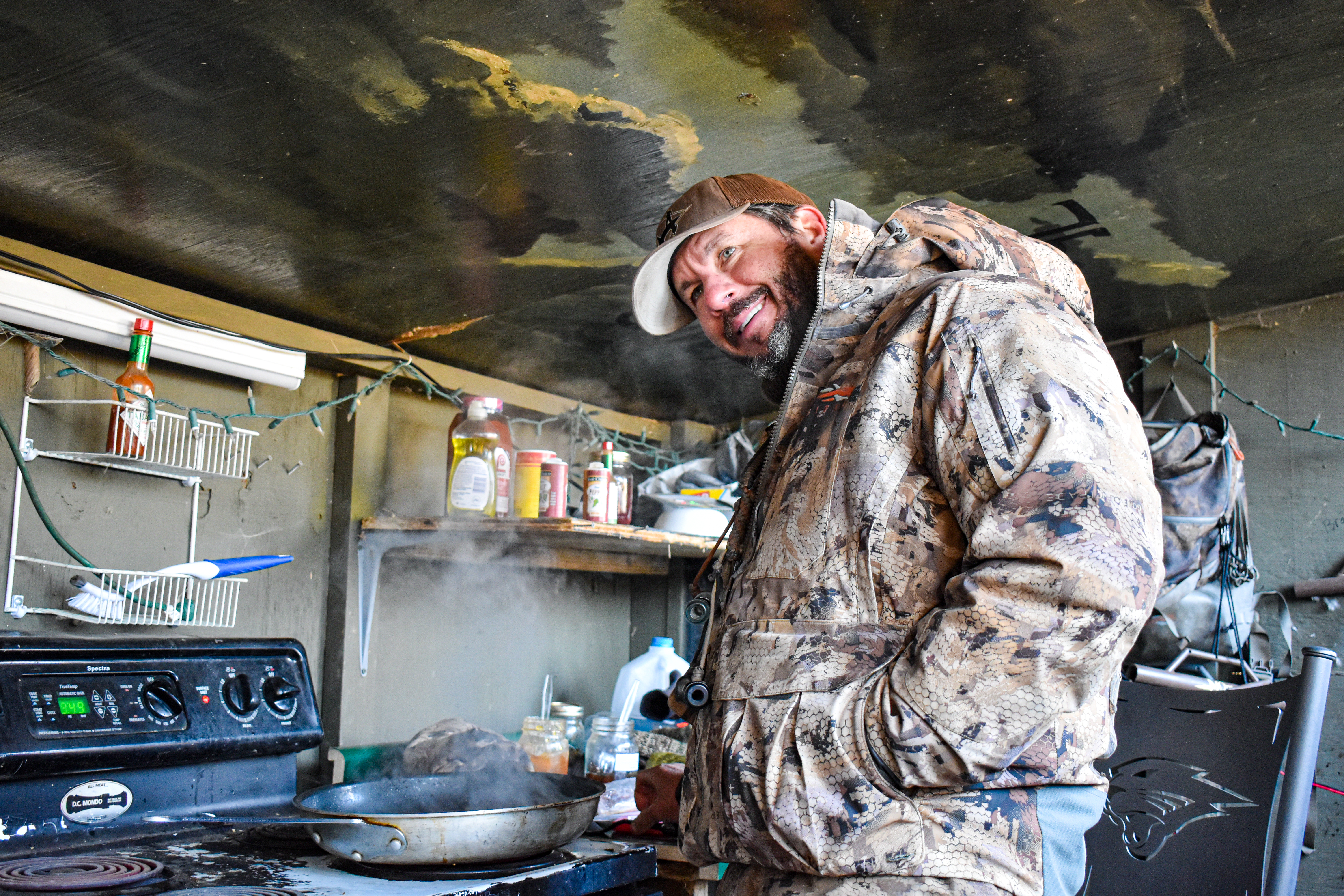 Hunter Ira McCauley stands under a painted ceiling mural in a duck blind.