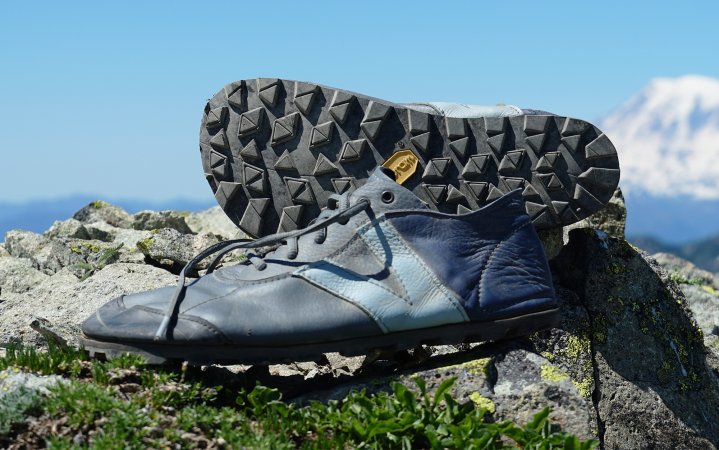  upper and outsole of the Softstar Primal against a mountain backdrop