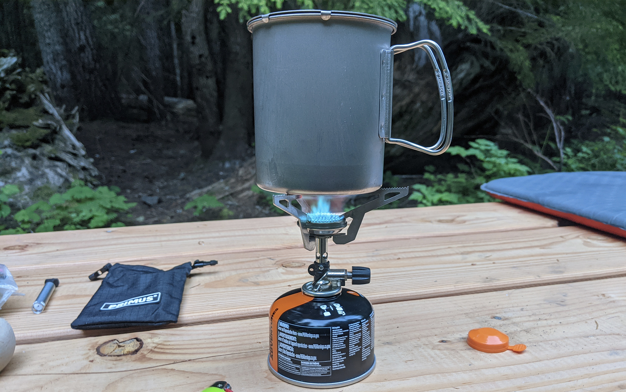 cooking with the primus express on a picnic table