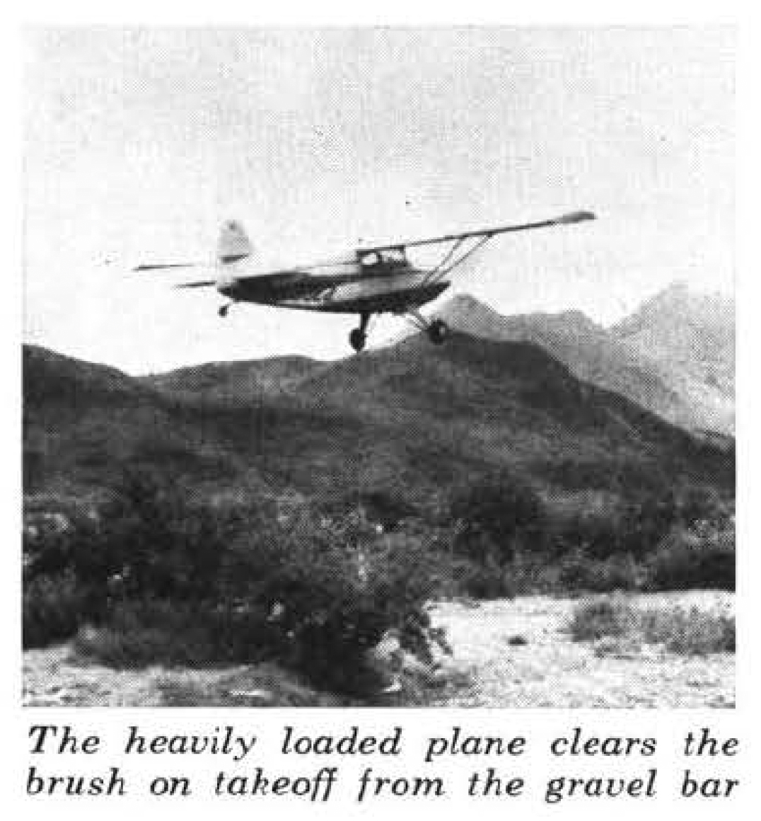 An old biplane taking off from a gravel bar in an old photo.