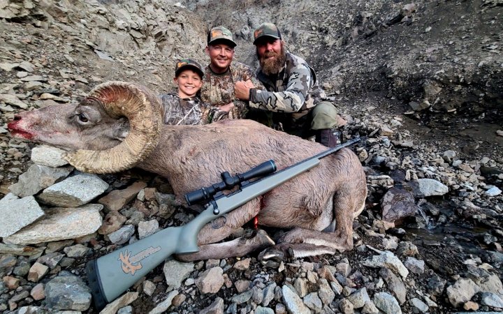 A group of hunters with a bighorn ram.