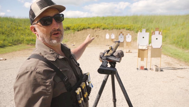 Screenshot of John B Snow talking to the camera in a YouTube video about a shotgun.